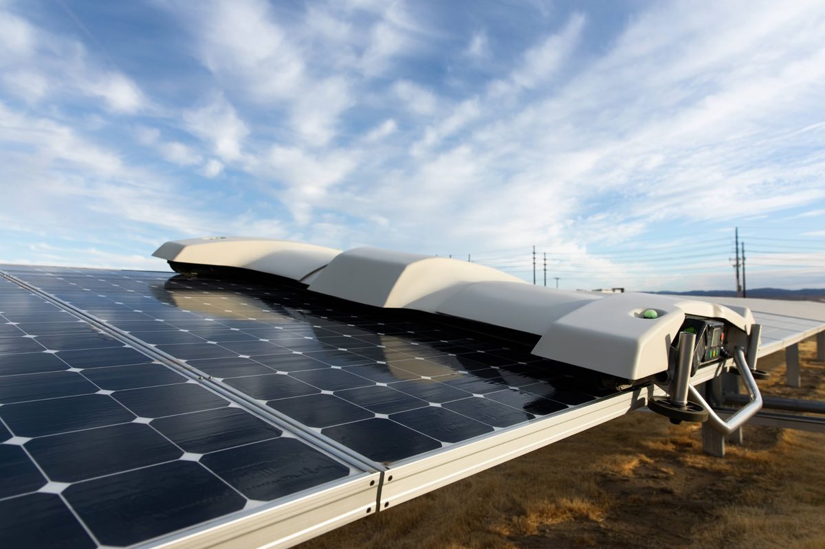 Robotic solar-panel cleaner on a panel array